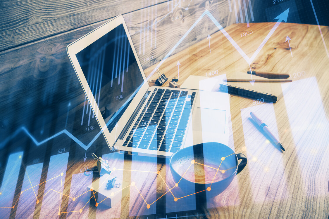 Double exposure of graph and financial info and work space with computer background. Concept of international online trading.